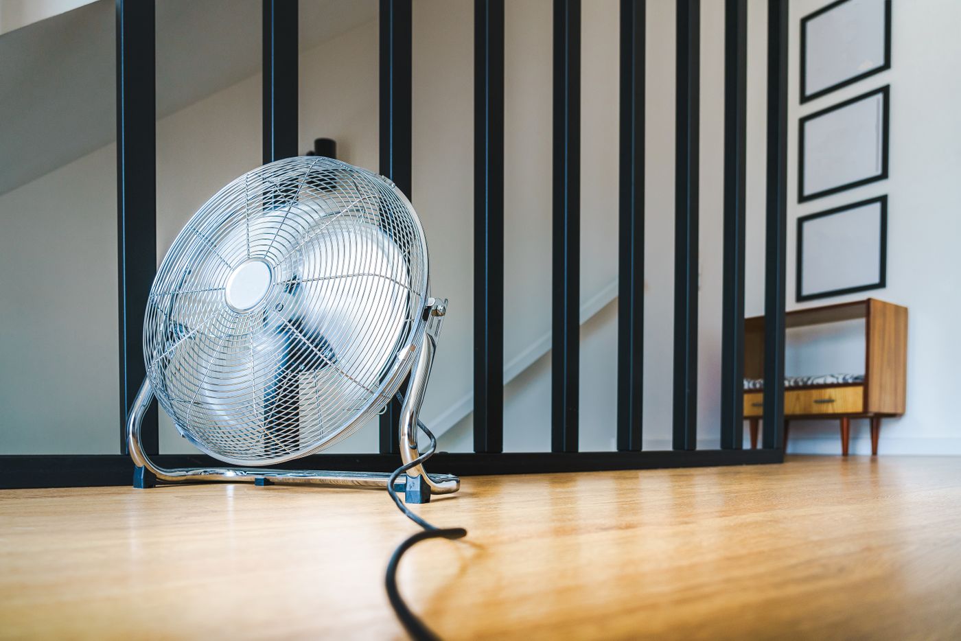 Commercial air movers drying a room after water damage from firefighting